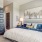 Elegant bedroom at Camber Ranch featuring a large bed with stylish bedding, bedside tables, lamps, and a spacious, well-lit area with tasteful decor