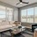 Living room at Camber Ranch with stylish furniture, a large area rug, decorative lighting, and large windows allowing natural light to fill the space
