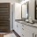 Modern bathroom at Camber Ranch with a sleek sink, mirror, and spacious shower area