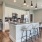 Modern kitchen at Camber Ranch with sleek cabinetry, a central island with seating, high-end appliances, and a spacious layout