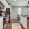 Modern kitchen at Camber Ranch with stainless steel appliances, a large island with seating, and sleek cabinetry