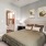 Stylish bedroom at Camber Ranch with a large bed, nightstands, and a modern lamp, featuring neutral-colored walls and cozy decor