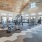 Fitness center at Camber Ranch with modern exercise equipment, including cardio machines and free weights, set in a well-lit