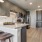 Modern kitchen at Camber Ranch with sleek cabinetry, stainless steel appliances and a central island with seating