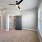 Empty primary bedroom area with neutral-colored walls and flooring