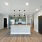 Modern kitchen at Camber Ranch featuring sleek cabinetry, a large island, stainless steel appliances, and stylish countertops
