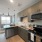 Modern kitchen at Camber Ranch with sleek cabinetry, a large island with barstool seating, stainless steel appliances, and well-organized counter space